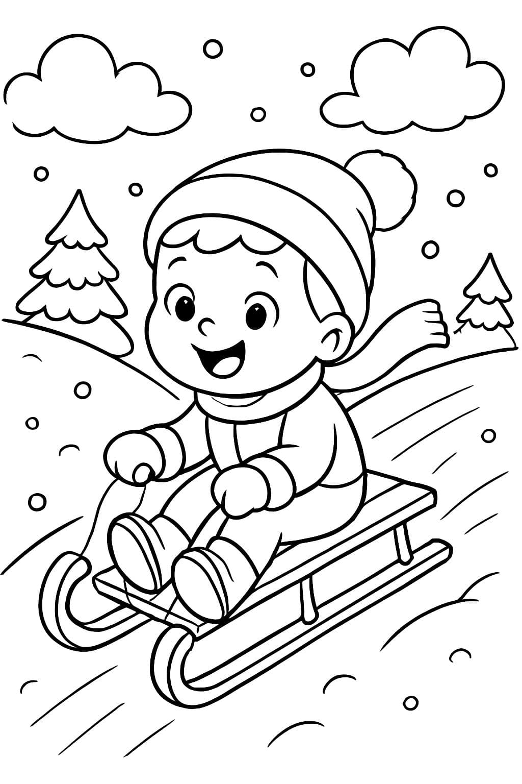 Niño de 3 años deslizándose por una colina nevada.